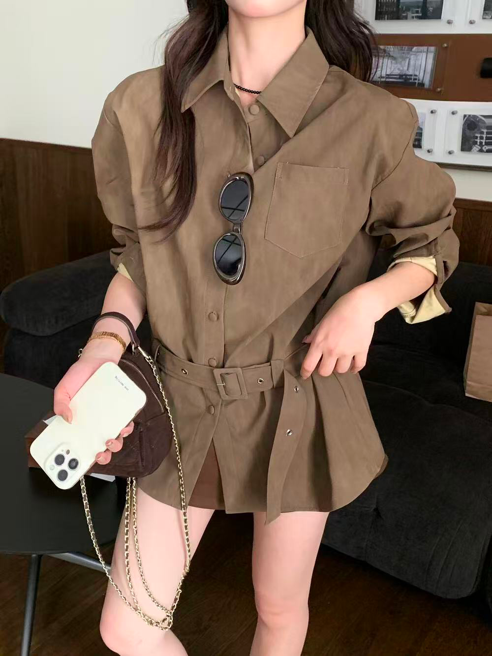 A loose casual shirt with a lady's belt A loose casual shirt with a lady's belt