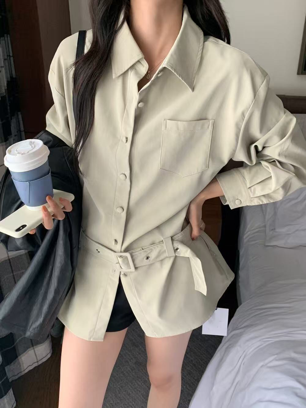 A loose casual shirt with a lady's belt A loose casual shirt with a lady's belt