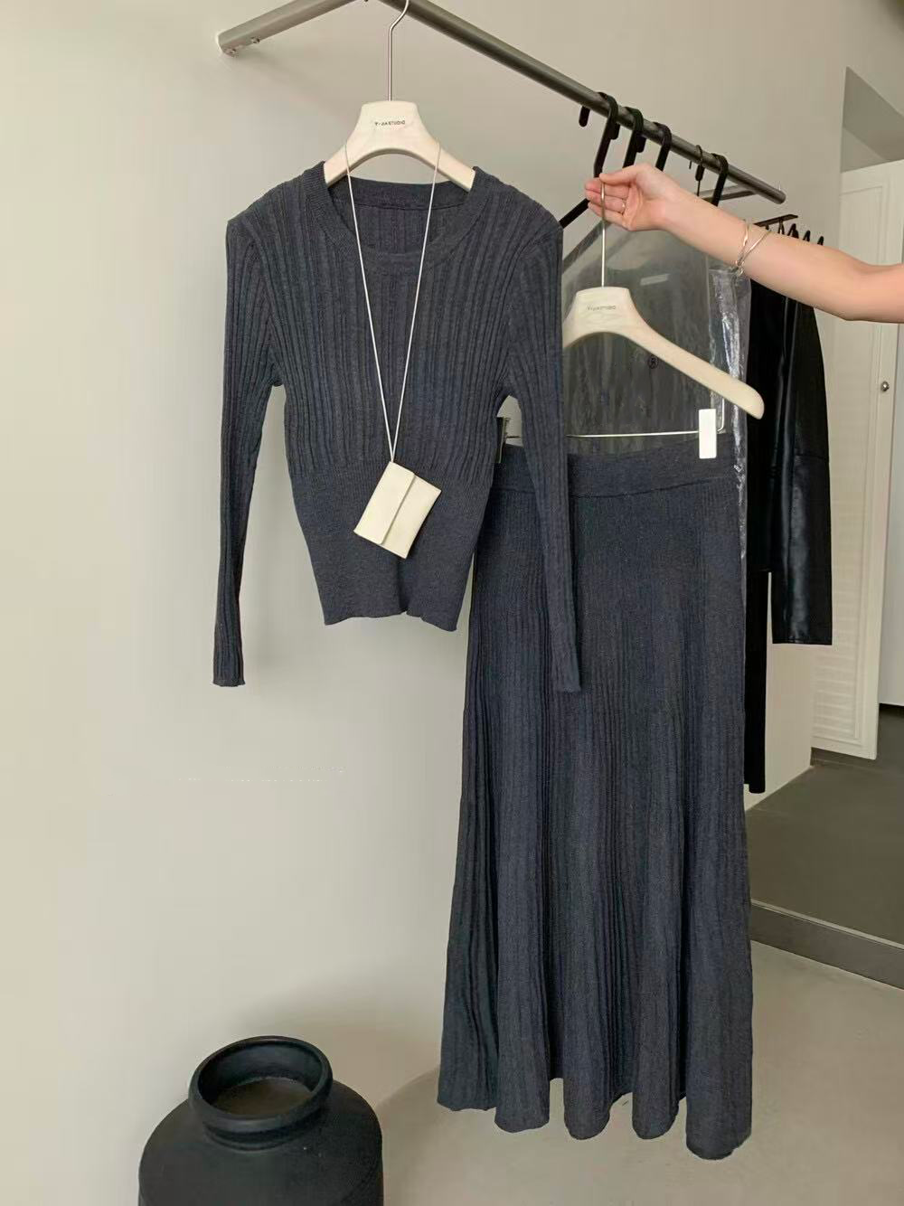 A women's knitted top skirt set