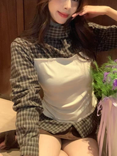 A long-sleeved top with checkered and color-blocking patterns for women