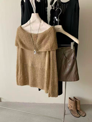 A lady's knitted top paired with a brown leather skirt