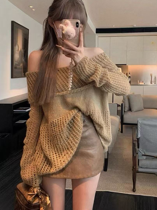 A lady's knitted top paired with a brown leather skirt